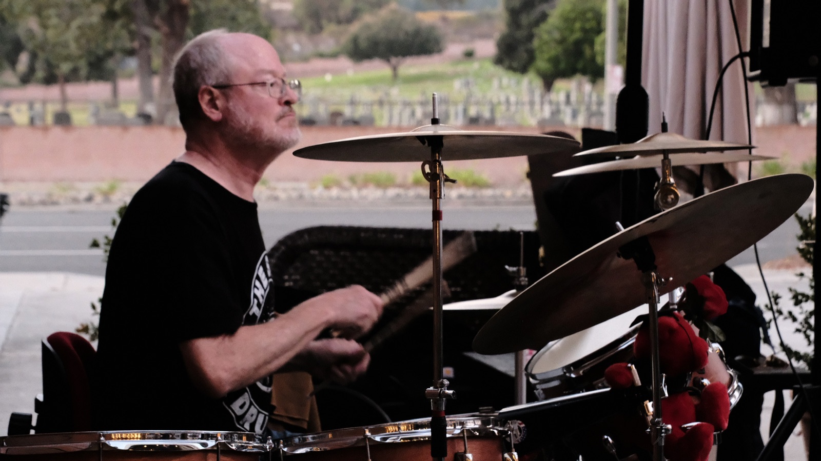 Drummer mid-song behind the cymbals